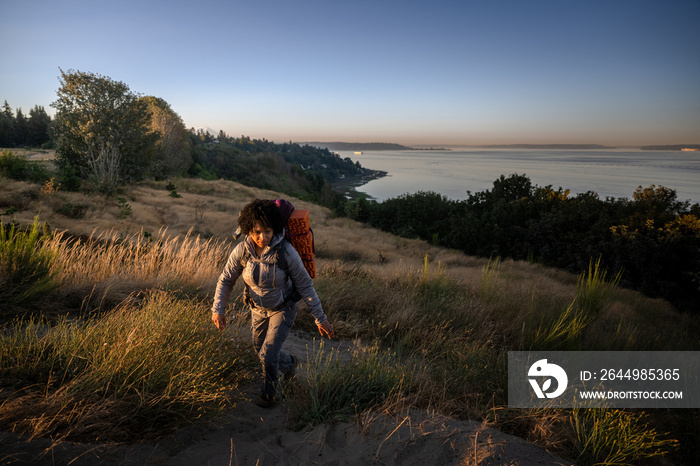 U.S. Army female soldier putting in the miles with an early morning hike in the NorthWest.