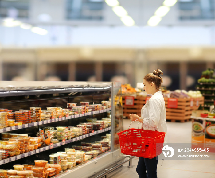 Woman choosing a dairy products at supermarket