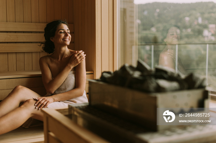 Young woman relaxing in the sauna