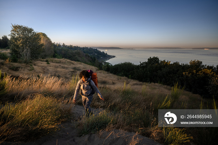 U.S. Army female soldier putting in the miles with an early morning hike in the NorthWest.