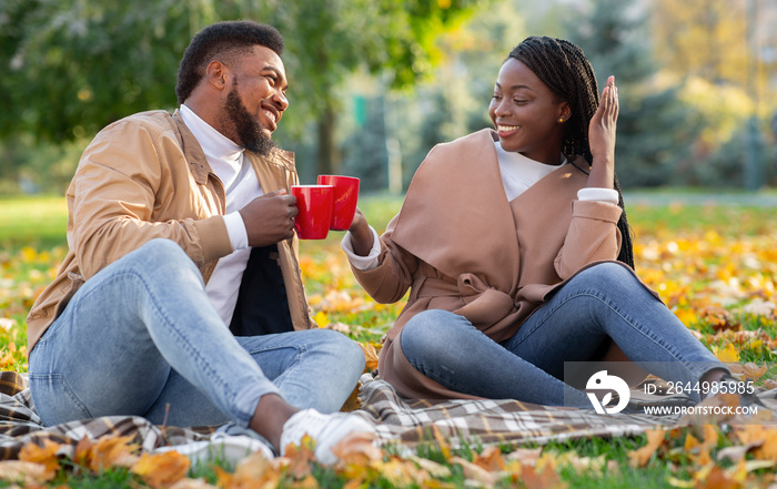 Romantic afro couple spending time together in autumn park