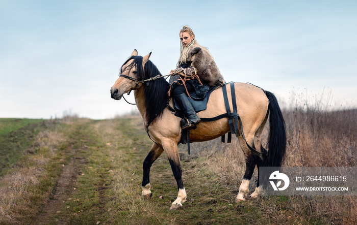 Warrior viking blonde female riding a horse - Medieval movie scene