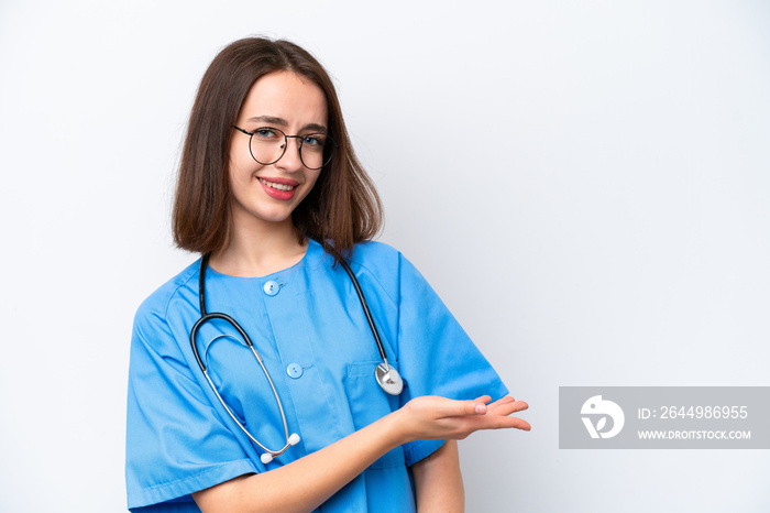 Young nurse Ukrainian woman isolated on white background presenting an idea while looking smiling towards