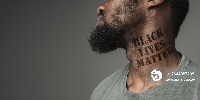 Close up black man tired of racial discrimination has tattooed slogan black lives matter on his neck. Concept of human rights, equality, justice, problem of violence and racism, discrimination. Flyer.