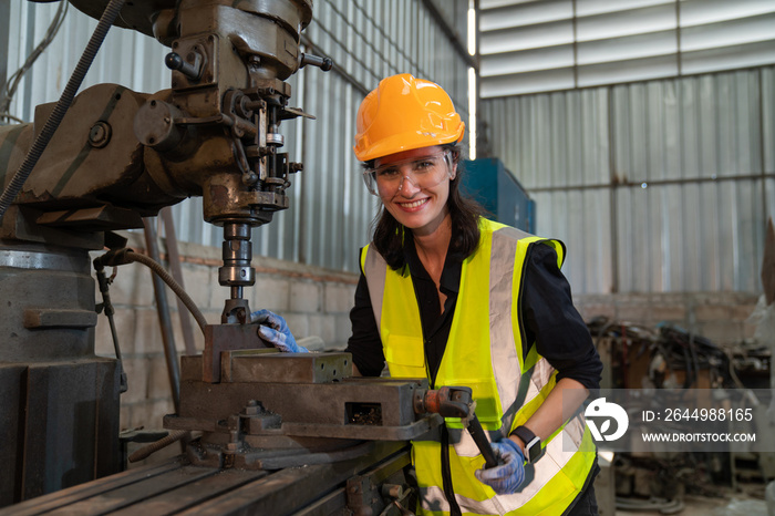 Female technician worker checking and repair pressing metal machine at factory, Machine maintenance technician operation concept.