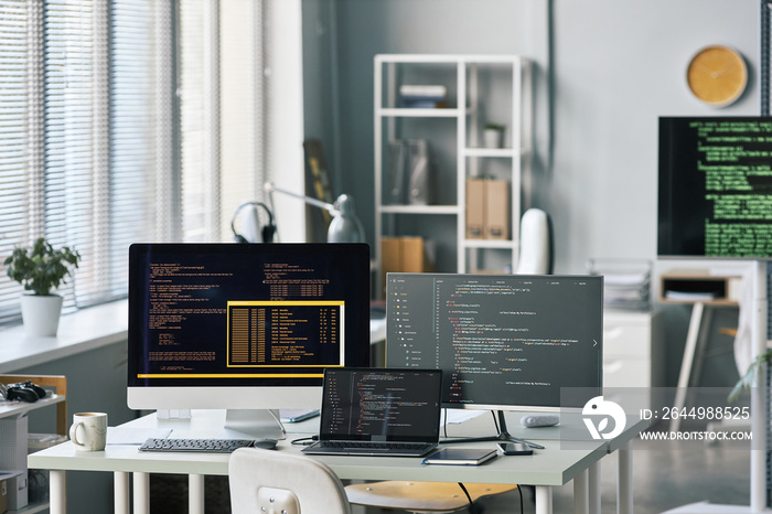Programming code on multiple screens in office of IT company