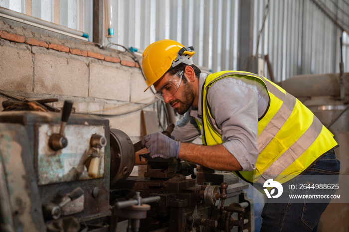 Male technician worker checking and repair pressing metal machine at factory, Machine maintenance technician operation concept.