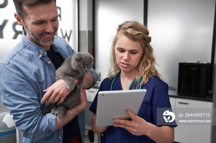 Female vet showing the medical tests on the tablet