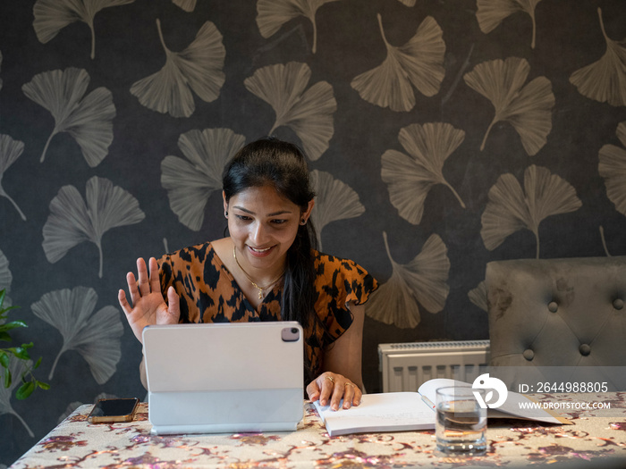 Woman working on tablet from home