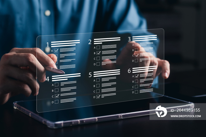 businessman using laptop to do online survey online exam Choosing the right answer in the exam, filling out an online survey form. Answer the test questions.
