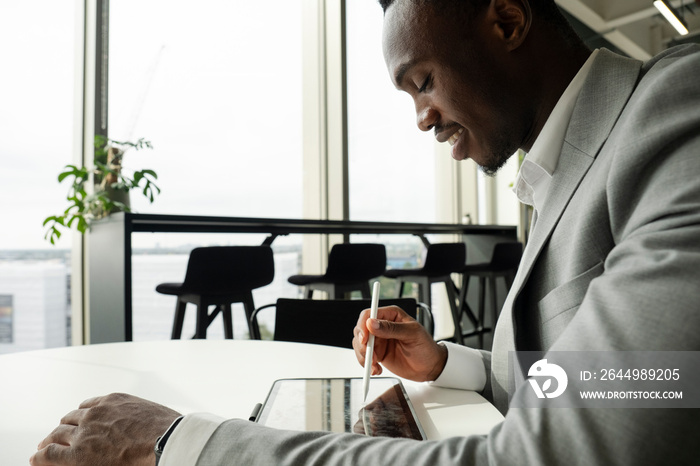 Young businessman using digital tablet in office