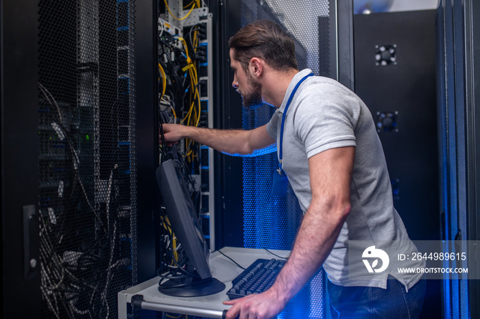 Man with badge in server room checking