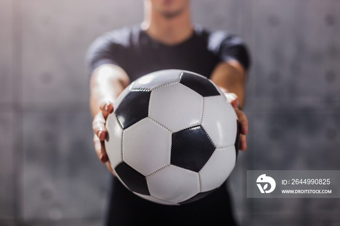 Man holding soccer ball in his hands