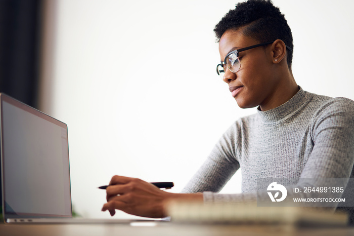 African American female manager typing on laptop keyboard