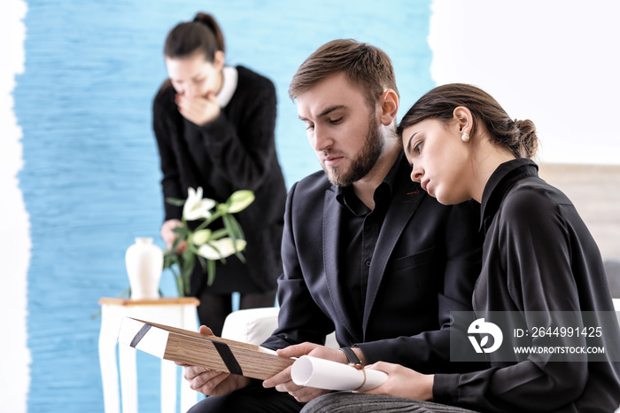 Couple pining after their relative at funeral