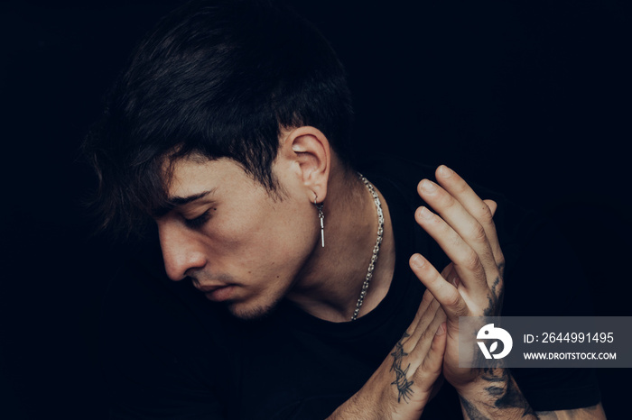 Young man with tattoos clapping the hands