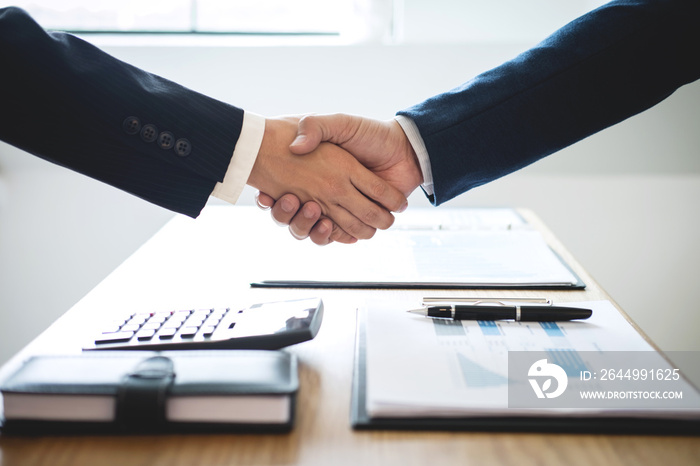 Handshake of two business people after contract agreement to become partner