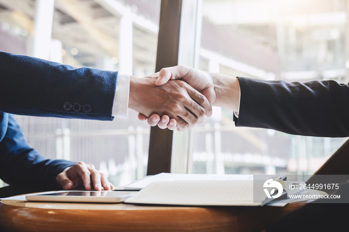 Handshake of two business people after contract agreement to become partner