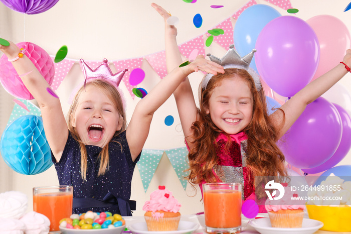 Cute little girls celebrating birthday at home