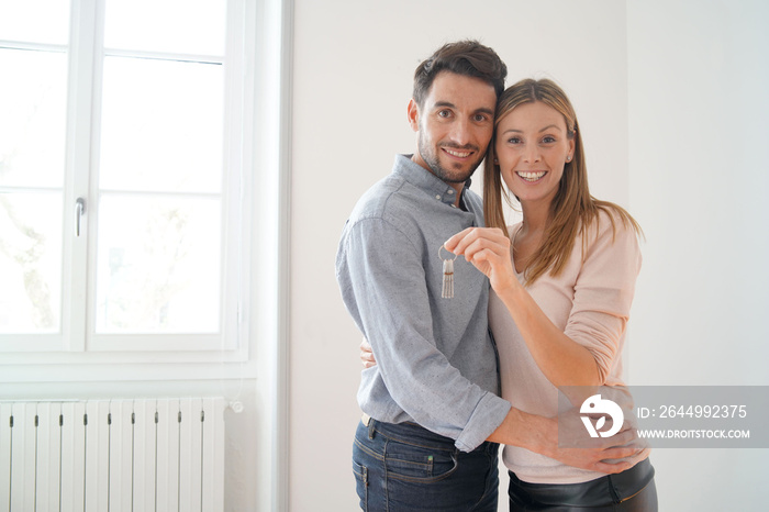 Happy couple with keys to new home