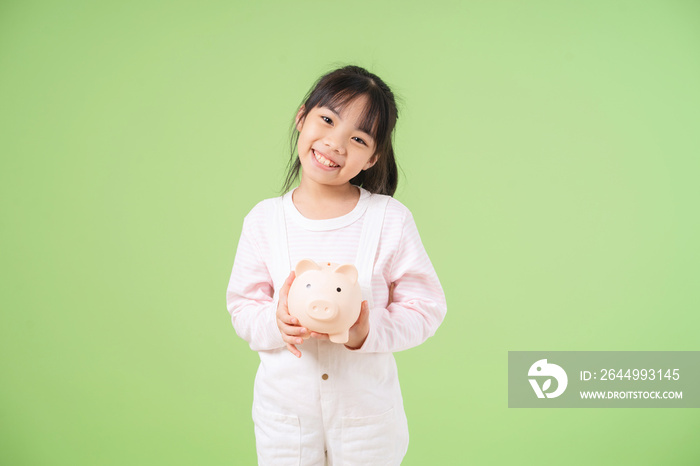 Portrait of Asian child on green background