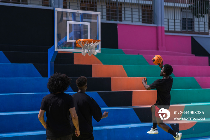 Man with afro hair trying to make a basket playing basketball