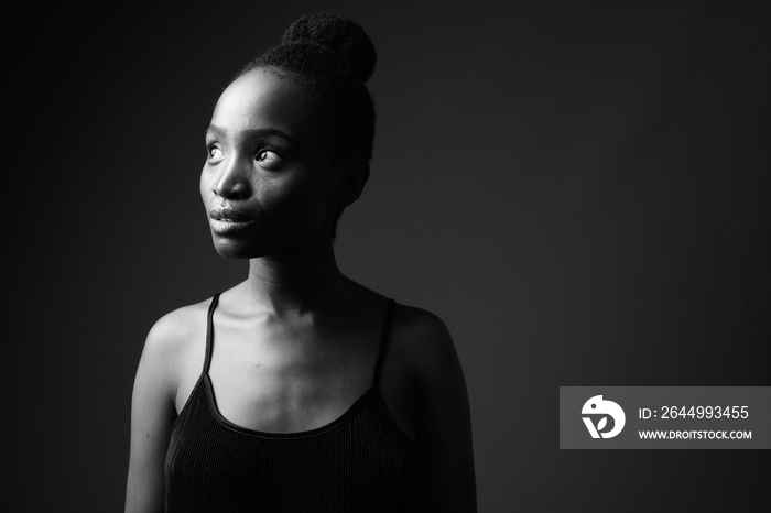 Black and white portrait of young beautiful African woman thinking