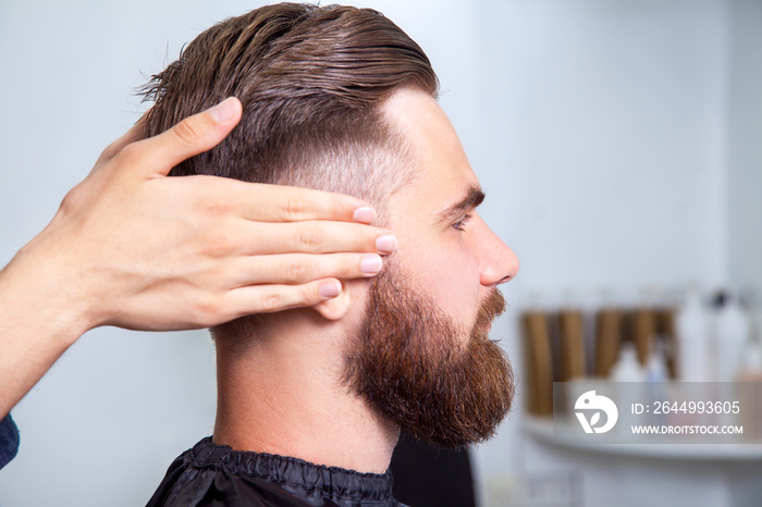 Bearded man sitting in the barbershop