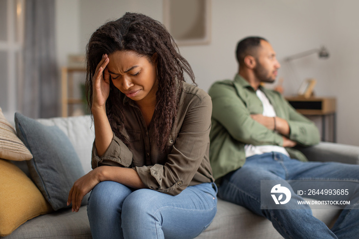 Unhappy African American Woman Crying Sitting Near Husband At Home