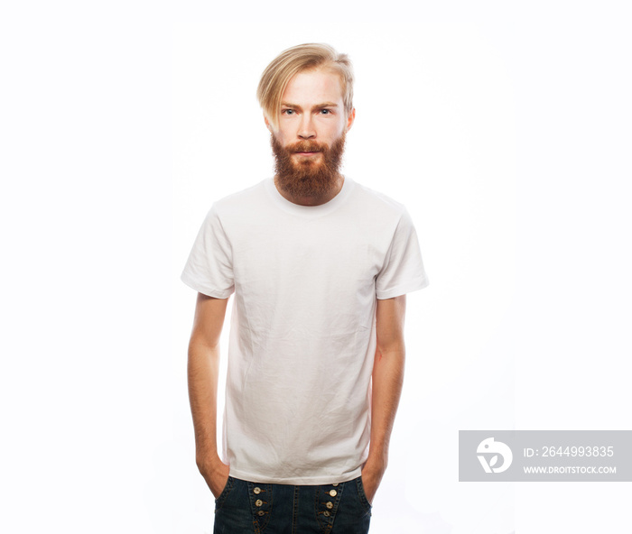 Portrait of young handsome hipster man with red beard looking at camera