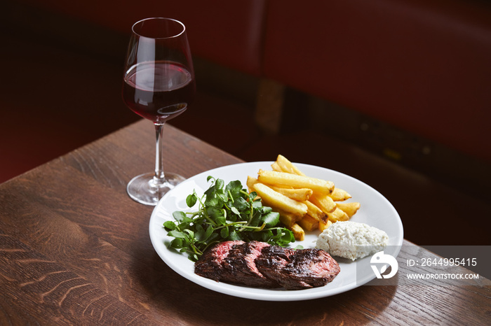 Red wine and steak in restaurant