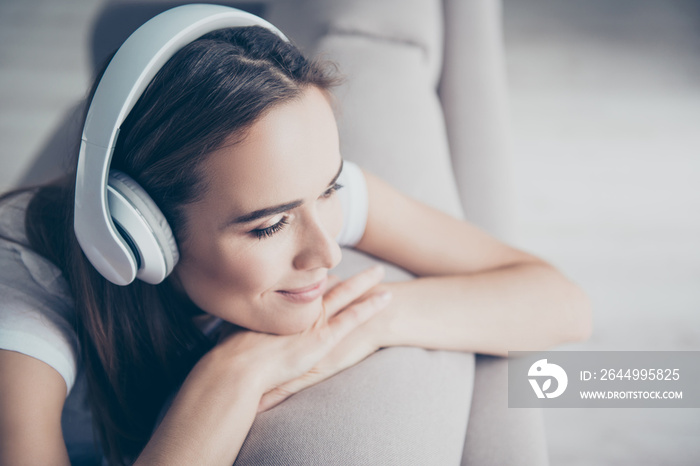 Chillout, satisfaction, therapy, wellness, leisure, lifestyle mode. Charmed adorable brown haired adorable model enjoying to the stereo sound in big modern ear phones in a room, nice break, good-day