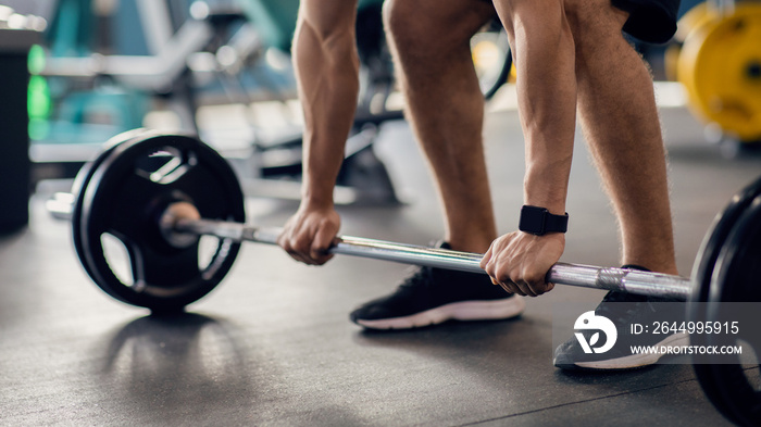 Portrait Of Unrecognizable Male Athlete Working Out With Barbell At Gym