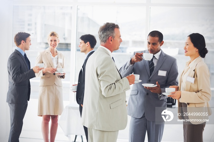 Business people chatting and drinking coffee at a conference