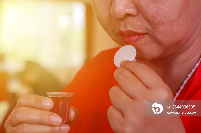 Women are holding wine and bread about to eat during the Eucharist Holy Communion in Sunday Church.