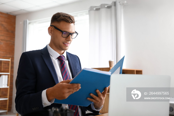 Young man working with documents in office