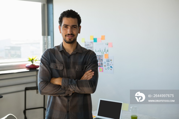 Portrait of young man standing at office