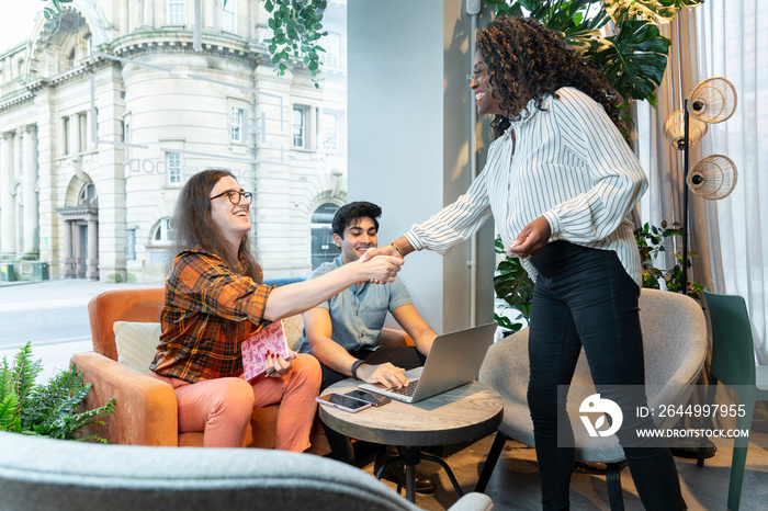 Colleagues greeting at business meeting in office