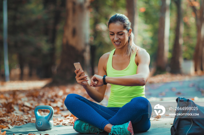 Woman Looking at Smart Watch after Outdoor Training