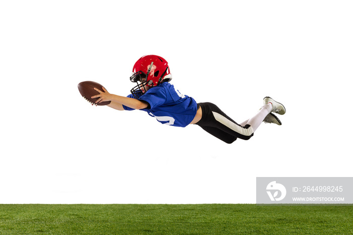 Athletic kid, beginner american football player in sports uniform and helmet training isolated on white background. Concept of sport, challenges, motion, achievements.