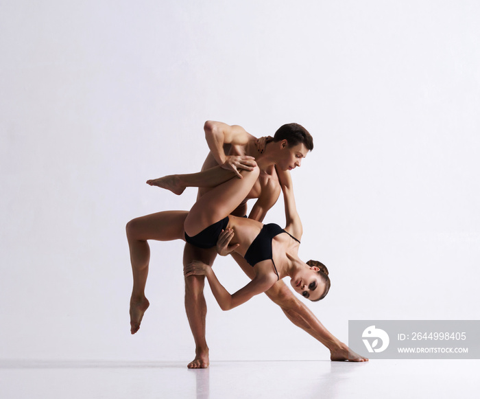 Couple of sporty ballet dancers in art performance