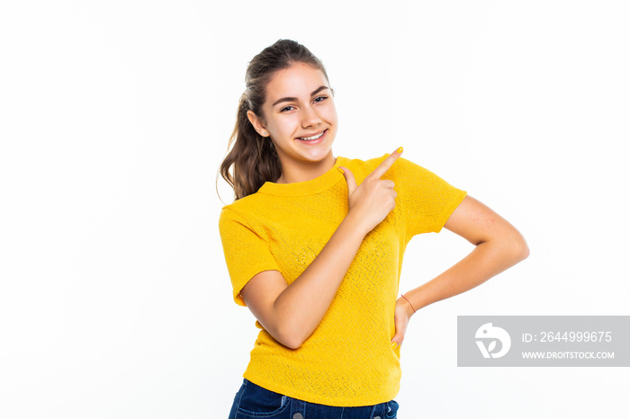 Portrait of a happy casual girl pointed up against white background