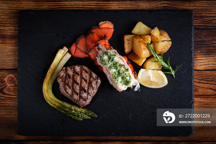 surf and turf on black stone plate