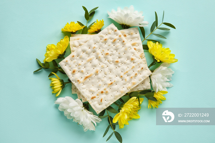 Jewish flatbread with flowers on color background