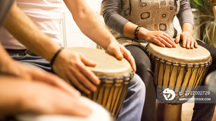 Close up of hands on african drums, drumming for a music therapy