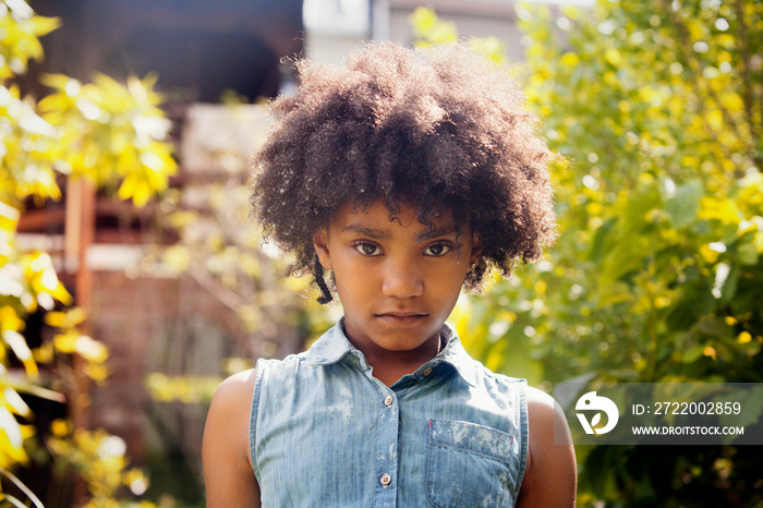 Portrait of girl standing in backyard