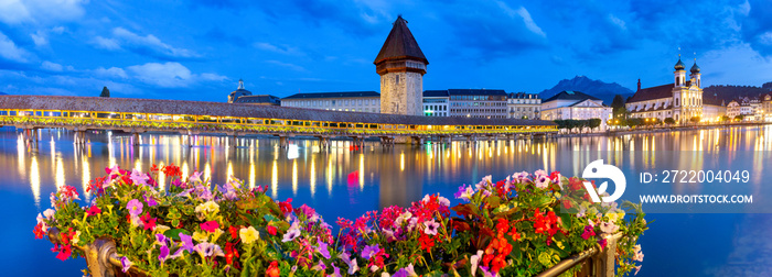 Lucerne. The famous Chapel, Kapellbrucke bridge at dawn in night lighting.