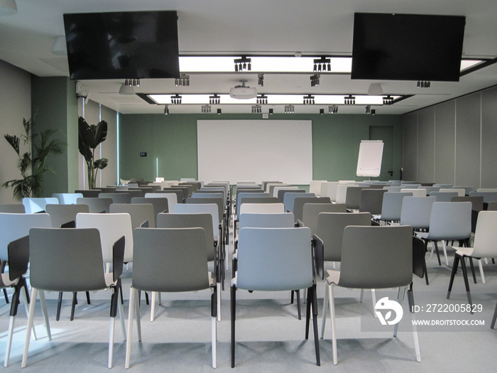 Modern interior of the class room with chairs and table. Modern pastel colors equipment in the confe