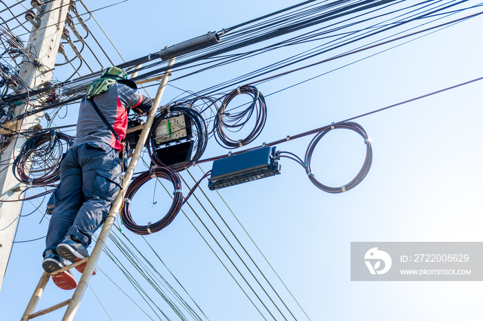 Technician man install cabinet on fiber optic cable system.