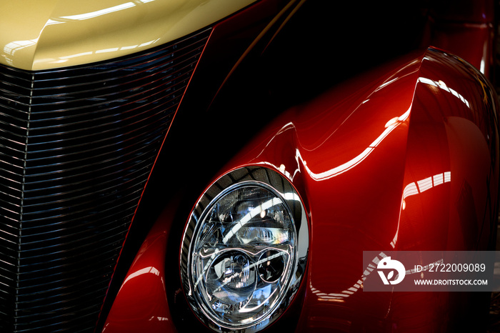 Close Up Of Red And Yellow Classic Car Headlight